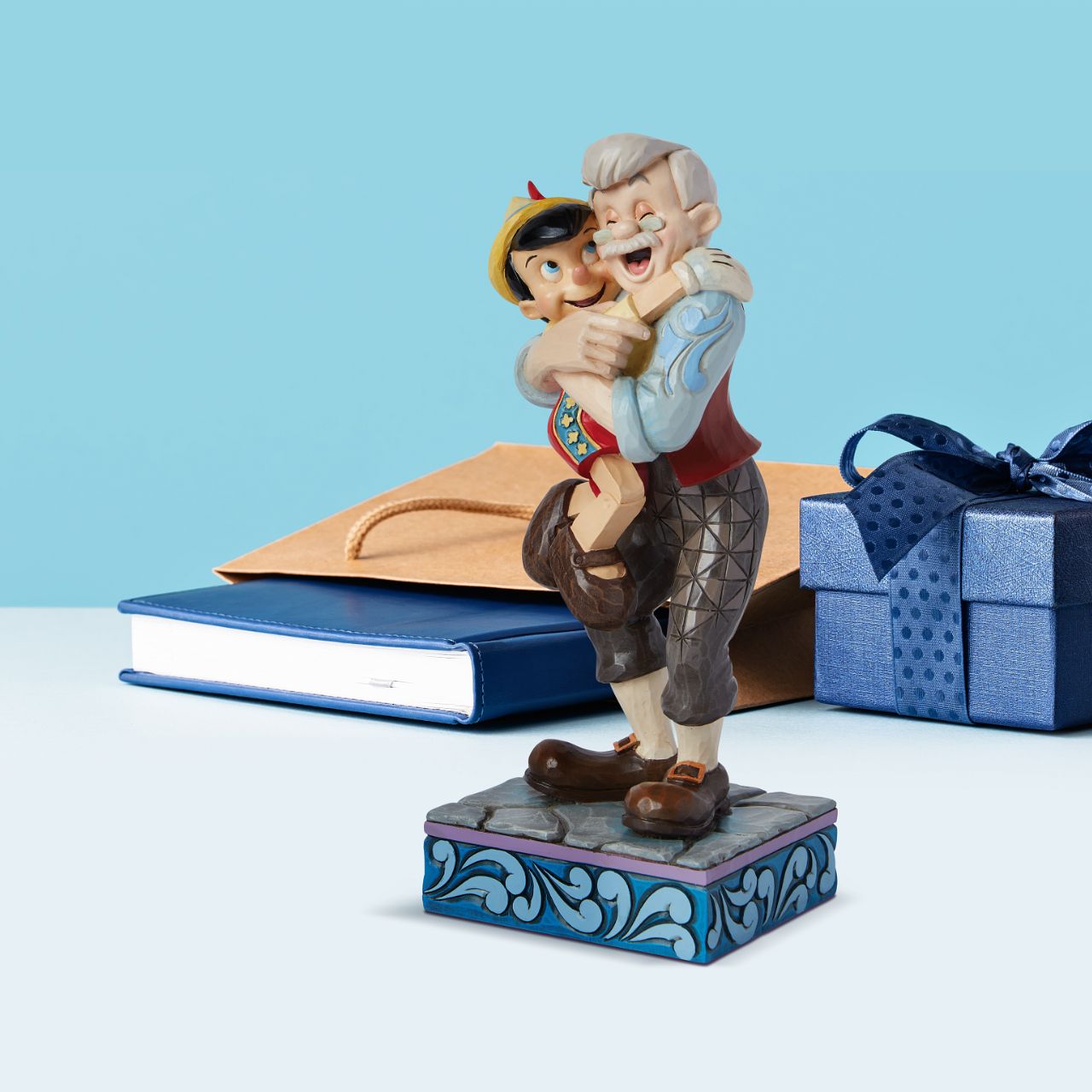 Gepetto and Pinocchio show the perfect love between a boy and his father. Hand painted for the Disney Traditions collection. Comes in a fully branded gift box.