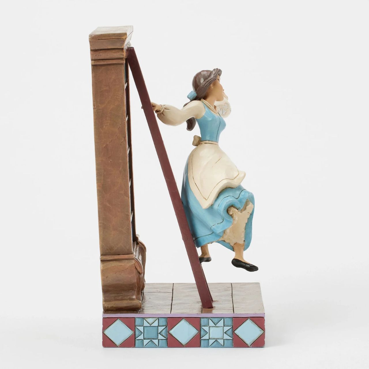 Celebrating the 35th anniversary of Beauty and the Beast in 2025, this lively Jim Shore scene captures Belle in her beloved library, singing as she glides gracefully on the bookshelf ladder. The gorgeous scene delights with exquisite rosemaling details.