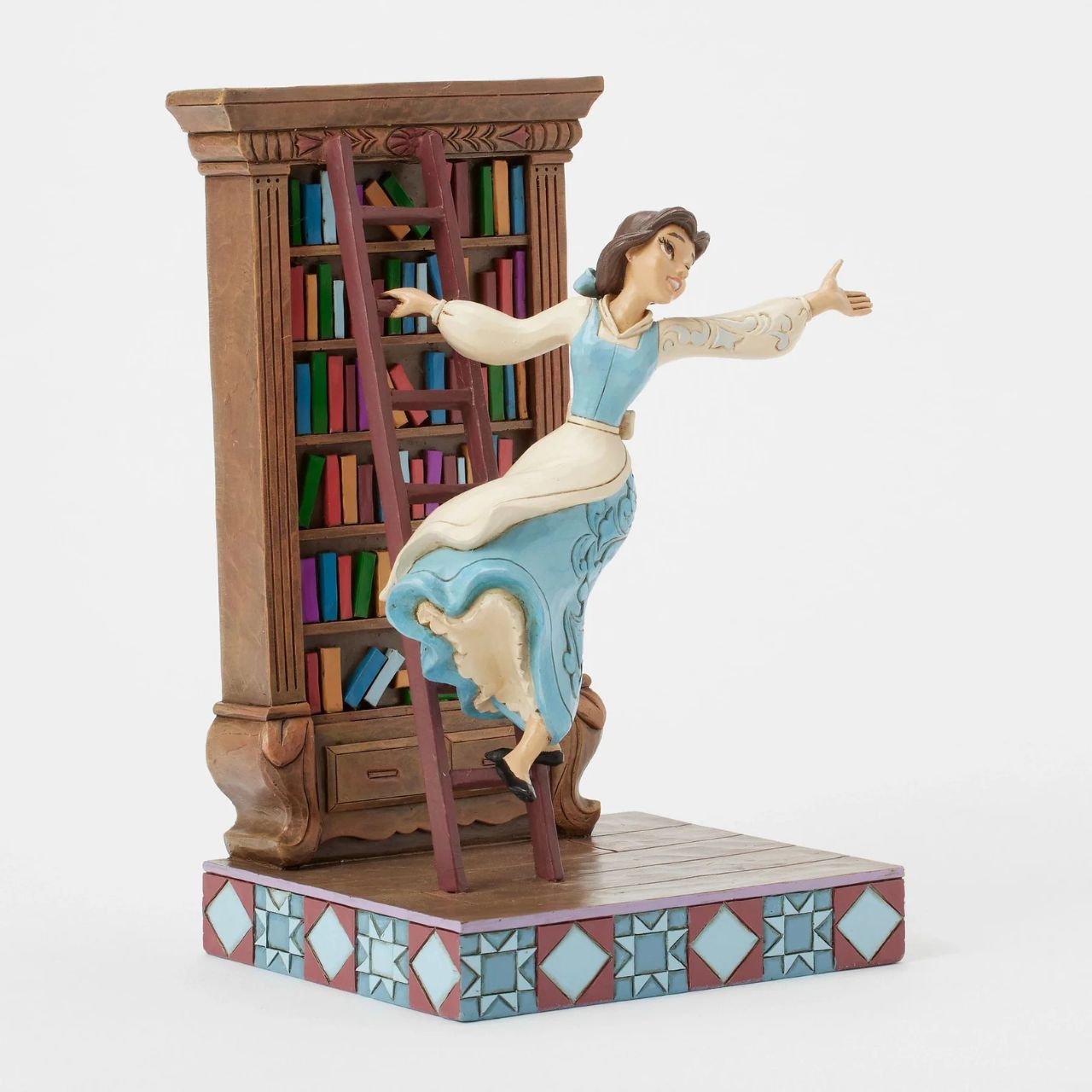Celebrating the 35th anniversary of Beauty and the Beast in 2025, this lively Jim Shore scene captures Belle in her beloved library, singing as she glides gracefully on the bookshelf ladder. The gorgeous scene delights with exquisite rosemaling details.