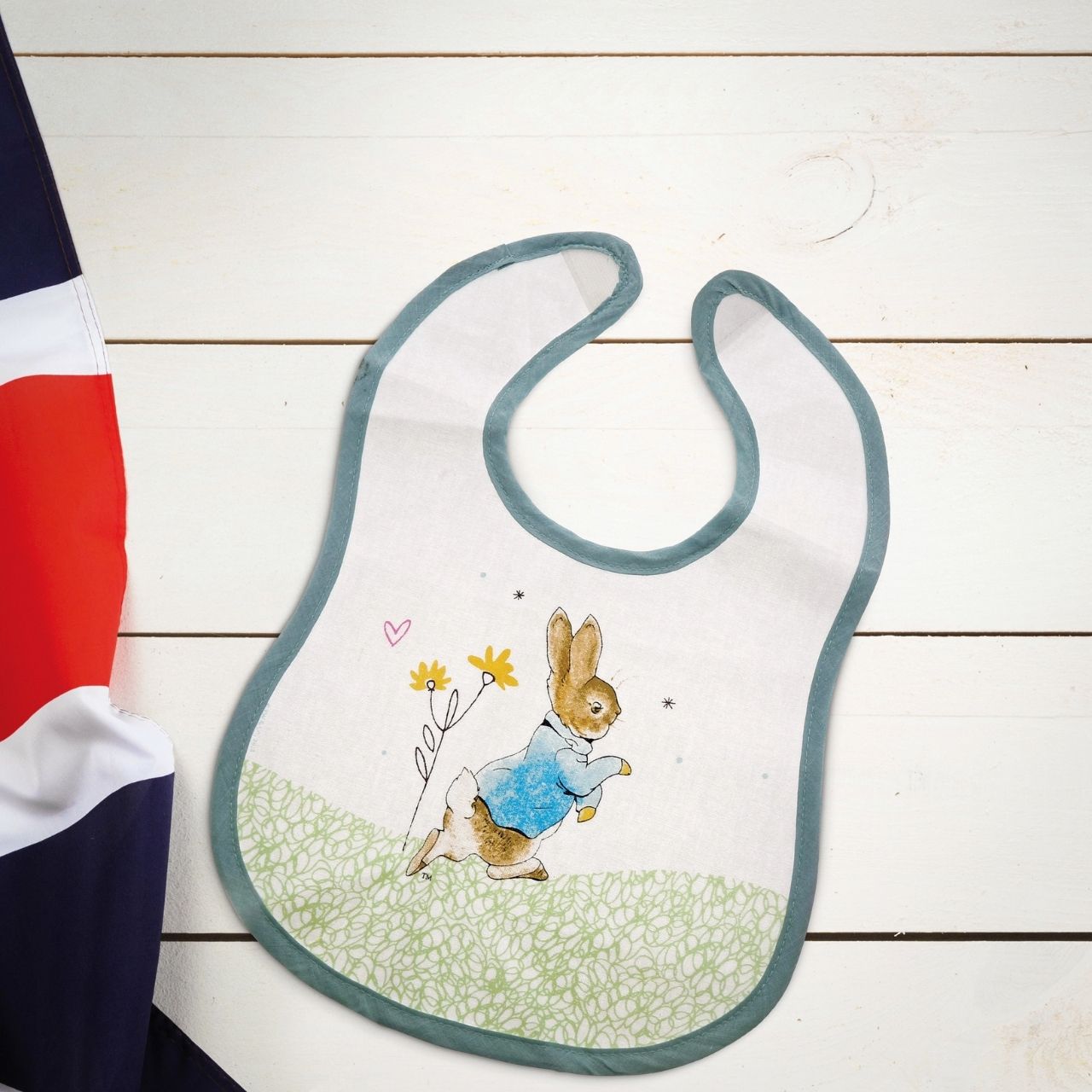 Beatrix Potter Peter Rabbit Children's Bib Make mealtimes super fun with this beautiful Flopsy Bib. This is a fun and practical bib, has been perfectly detailed with original Flopsy illustrations, taken from the Beatrix Potter stories. This bib is not only easy to wear, but practical too with its wipeable coating.