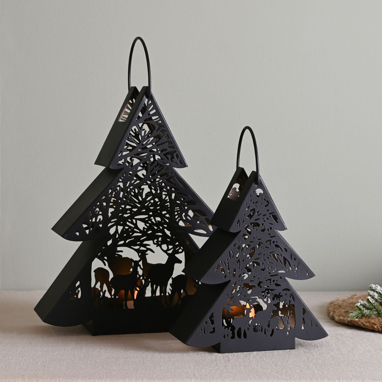 Black Tree Lantern Small A small black tree lantern by THE SEASONAL GIFT CO®. This enchanting lantern glistens with festive charm throughout the Christmas period.