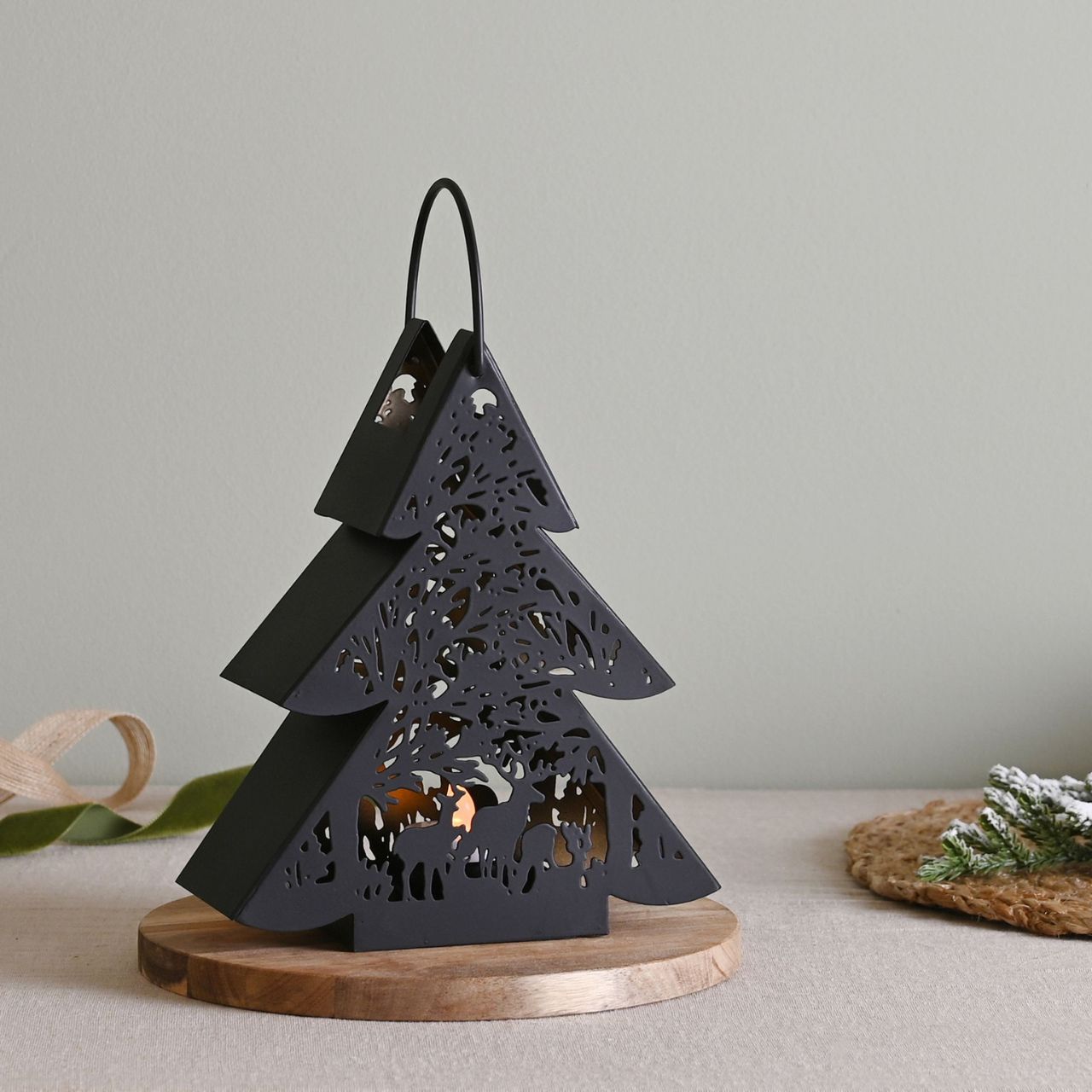 Black Tree Lantern Small A small black tree lantern by THE SEASONAL GIFT CO®. This enchanting lantern glistens with festive charm throughout the Christmas period.