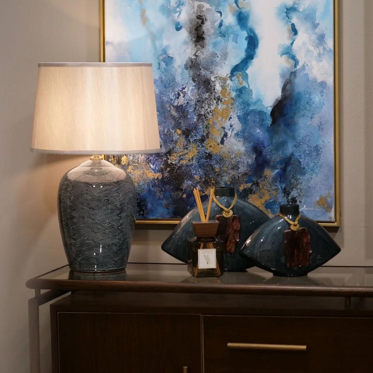 Blue Waves Lamp by Mindy Brownes Mindy Brownes Ceramic Lamp. Good lighting is essential for every home. Our ceramic collection is traditional yet timeless and featuring stunning designs, prints and patterns bursting with colour. This lamp features blue and navy wave details with a taupe linen shade.