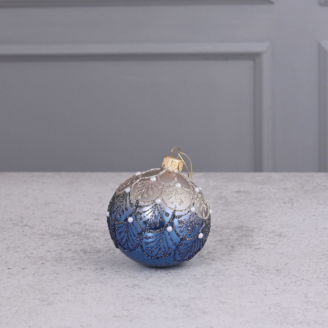 Celestial Blue Crystal Hand Decorated Ornamental Bauble A blue hand decorated crystal bauble from THE SEASONAL GIFT CO. This ornate Christmas bauble holds an abundance of elegance and will stand out amongst the tree branches this festive season.