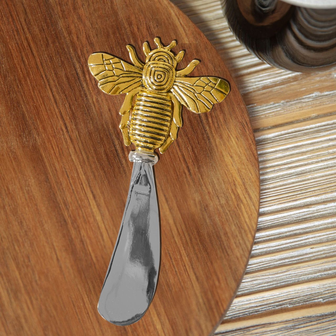 Round Acacia Cheese Board with Spreader Bee Design A beautiful round acacia wood cheese board with gold bee stainless steel cheese spreader in a branded gift box. From the Cheese & Wine Gifts collection by HESTIA - elegant gifts for the sophisticated partygoer.