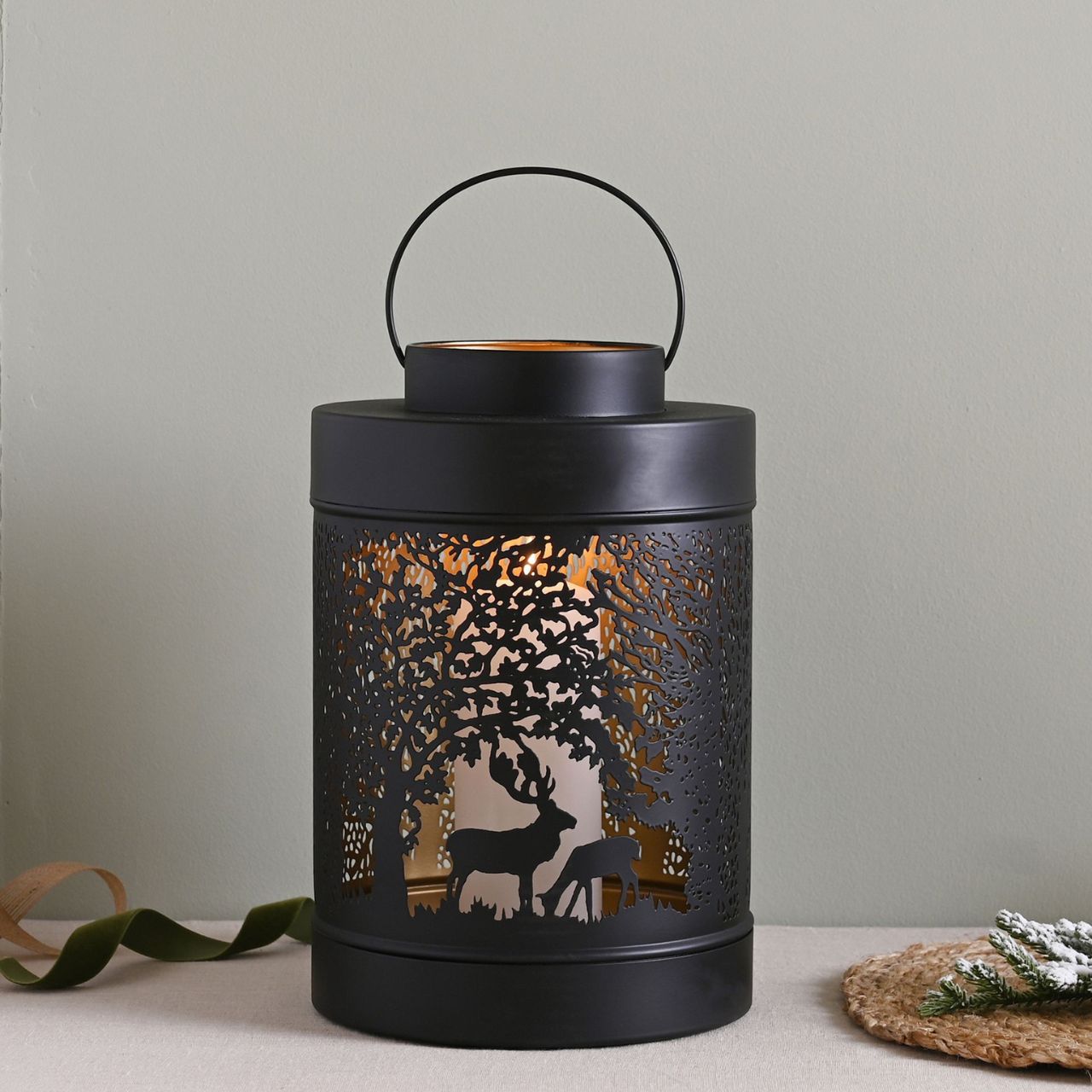 Black Forest Scene Round Lantern Large A large black forest scene lantern by THE SEASONAL GIFT CO. This enchanting lantern glistens with festive charm throughout the Christmas period.