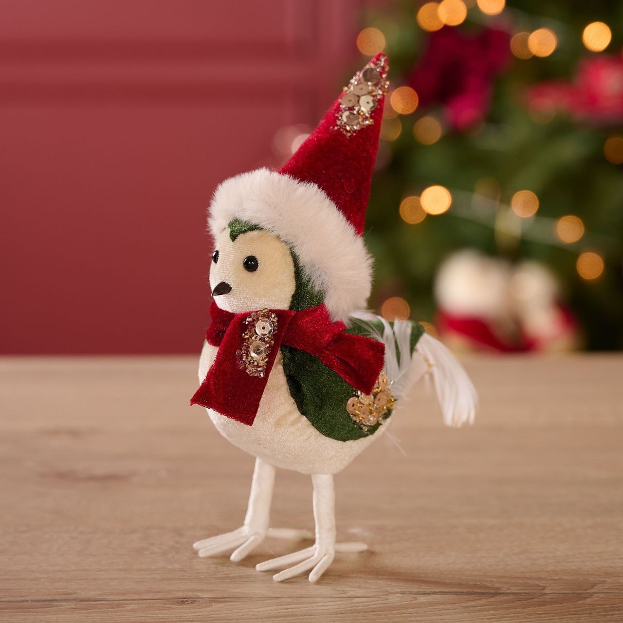 Bring some festive fun to the home this Christmas with this charming Christmas Red Velvet Bird Figurine. Perching proudly in a festive Santa hat and scarf, this cute little bird will add a touch of whimsy and charm to festive décor.