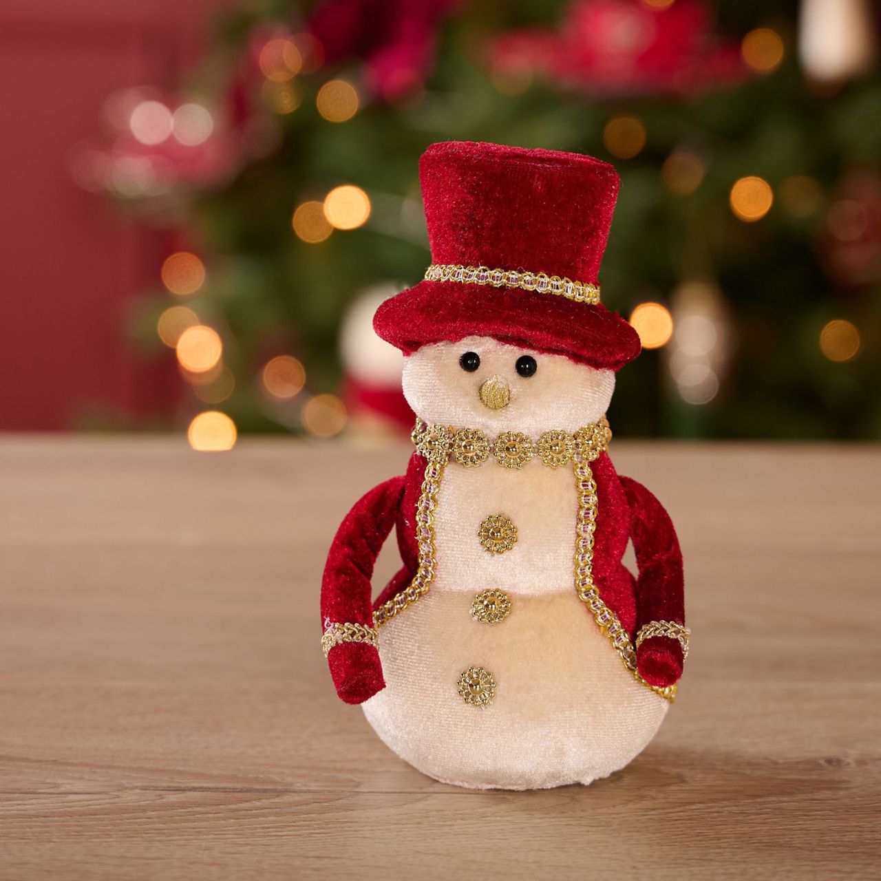 Add holiday charm to the home with this adorable Red Velvet snowman, ideal for spreading festive cheer. The snowman sports a red velvet hat and gold coloured scarf for a classic look. Perfect as a gift or décor, this plush snowman will warm hearts when placed on a mantel, shelf, or table.