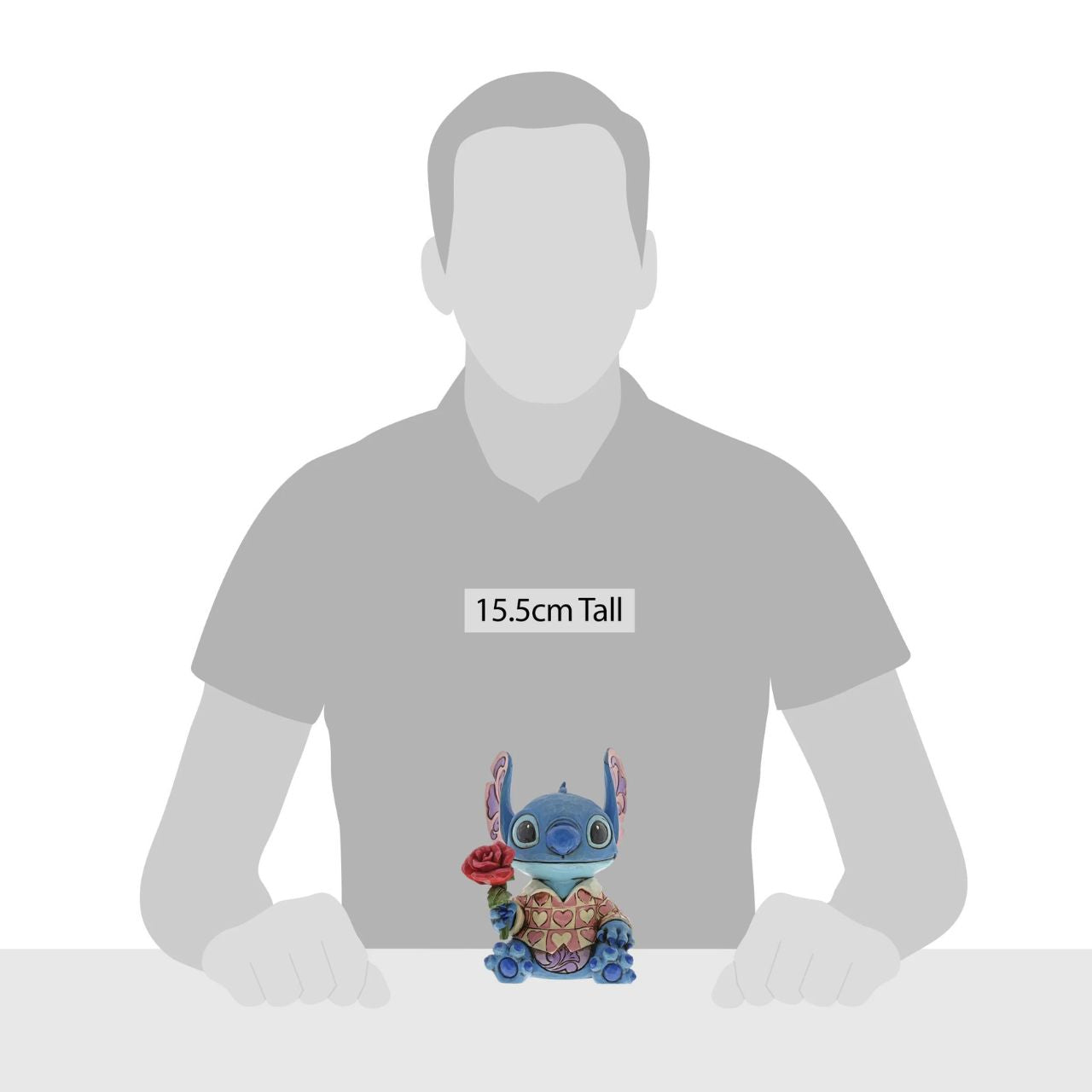 Jim Shore Clueless Casanova Stitch Figurine Stitch has transformed into a model citizen that Lilo would be proud of! Designed by Jim Shore, the adorable alien wears a heart-patterned shirt as he offers a single red rose. Stitch makes a great gift for your Ohana.
