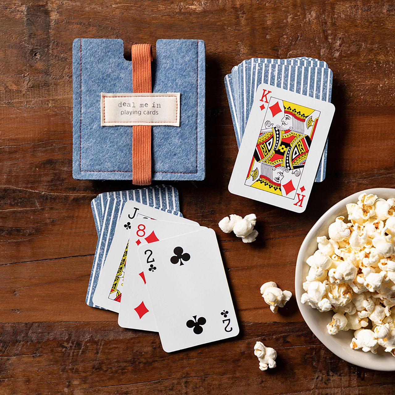 Deal Me in Playing Cards Our Deal Me In Playing Cards is a deck or playing cards like no another, covered with a blue and white striped back and stored in a blue-heathered felt pouch these are great to take with you anywhere.