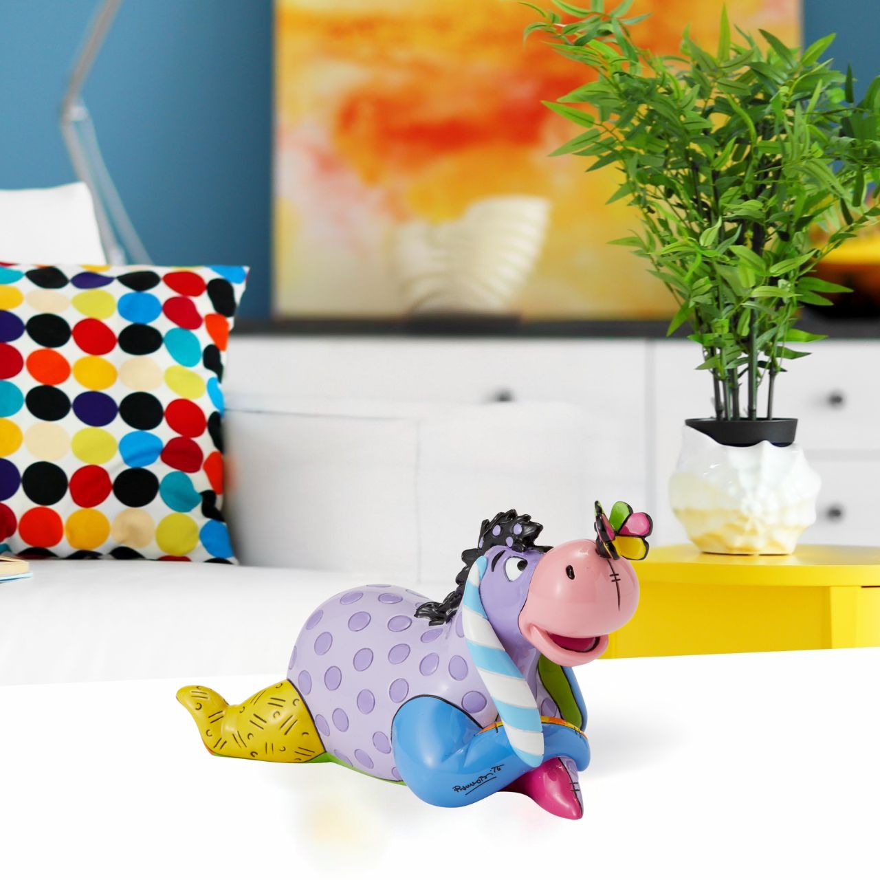 Eeyore enjoys nature and stares curiously at the butterfly perched on his nose. Romero Britto bestows a dose of optimism to our favourite gloomy donkey, reimagining Eeyore in lovely lavender and pretty polka dots.