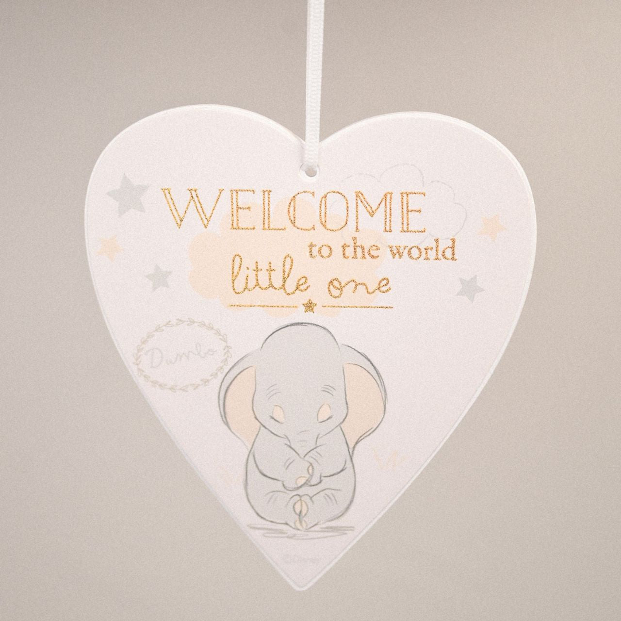 Heart-shaped decorative plaque with a baby elephant illustration and text 'Welcome to the world little one' on a beige background.