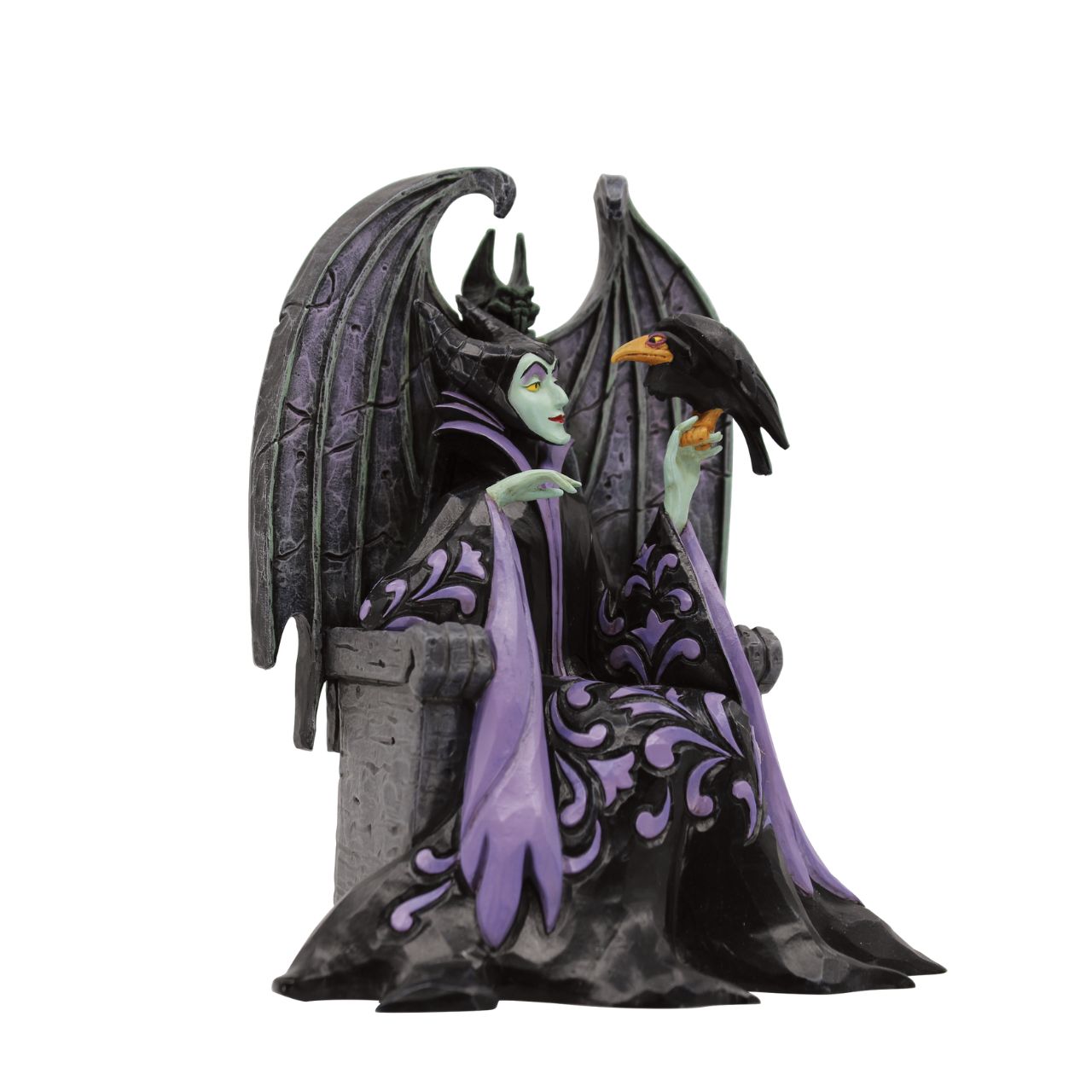 Maleficent sits atop her throne with her raven, Diavel. Dressed in her signature black with horned headdress, she is every piece the iconic villain from Sleeping Beauty. Designed by Jim Shore for his Disney Traditions collection.