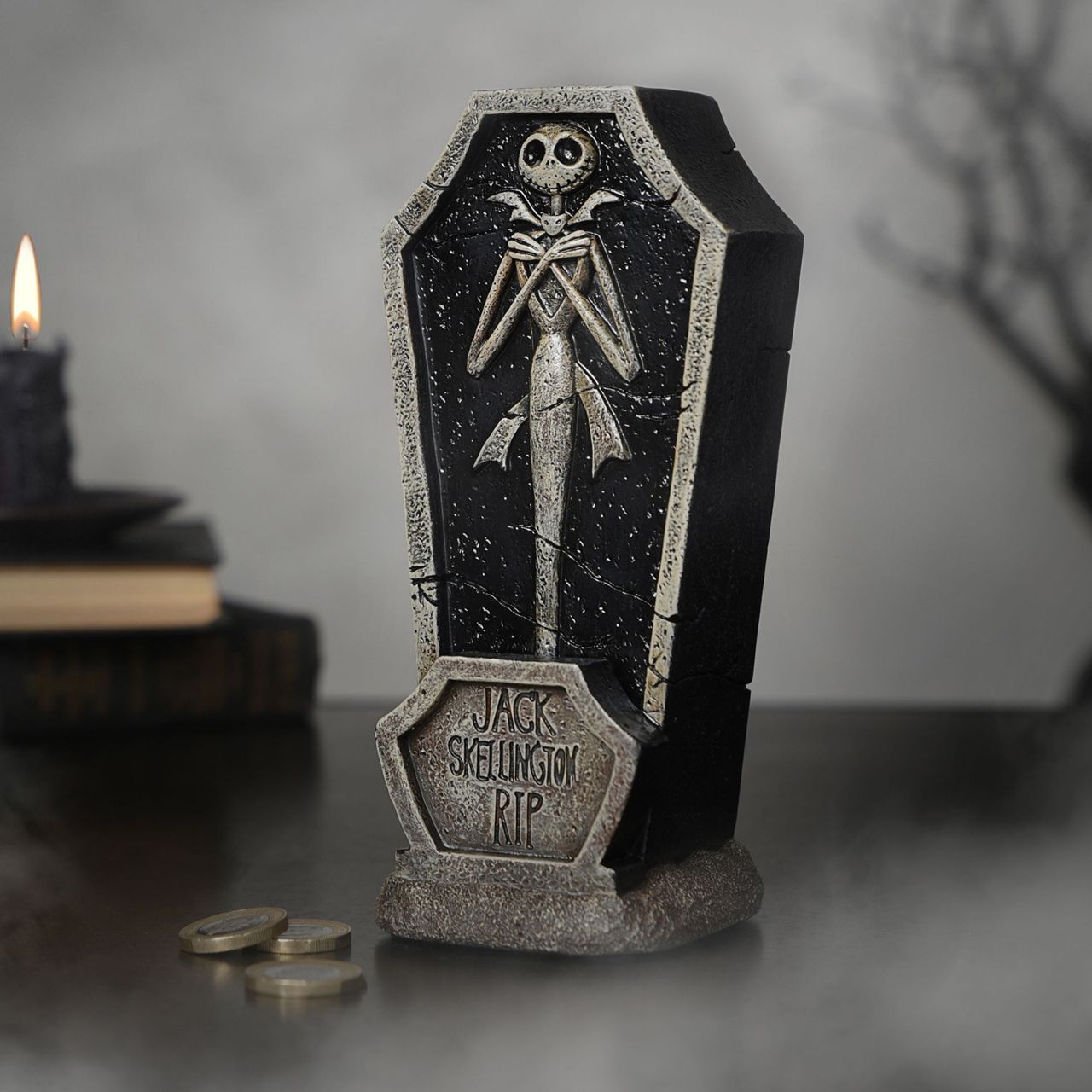 Bring the delightfully dark world of Tim Burton's The Nightmare Before Christmas into your home with this spooktacular Jack Skellington coffin money box. Featuring a gravestone design with a skeletal Jack Skellington figure and "R.I.P." text against an eerie background, it's perfect for fans of the classic film.