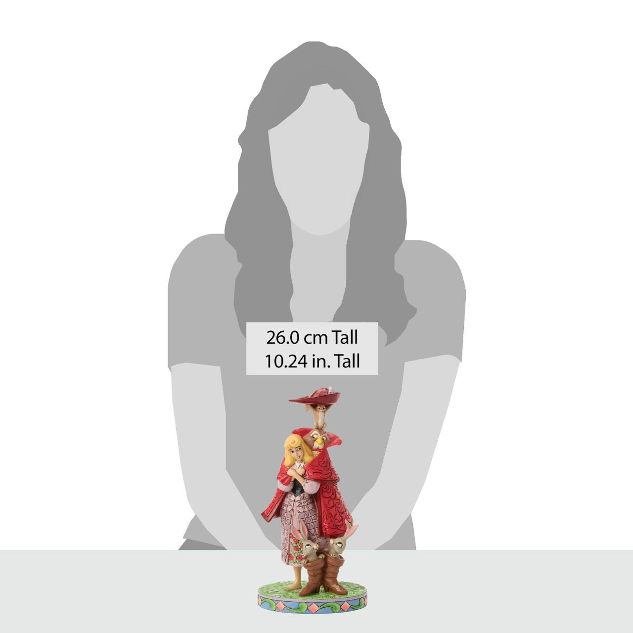 Aurora's forest friends transform into a man in a red coat as she searches for her prince. An owl, squirrel, and bunnies inside boots add charm to this captivating Jim Shore design, bringing the memorable movie scene to life with enchantment.