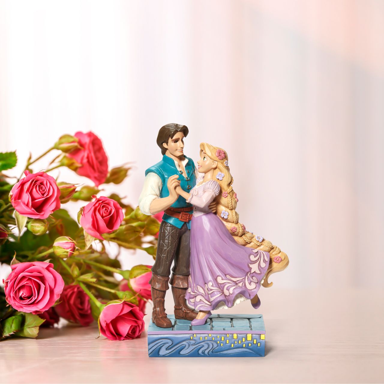 Based on the beloved characters from the 2010 film Tangled, this piece showcases Rapunzel & Flynn Rider happy together. Designed by award winning artist Jim Shore, hand crafted using high quality cast stone and hand painted.