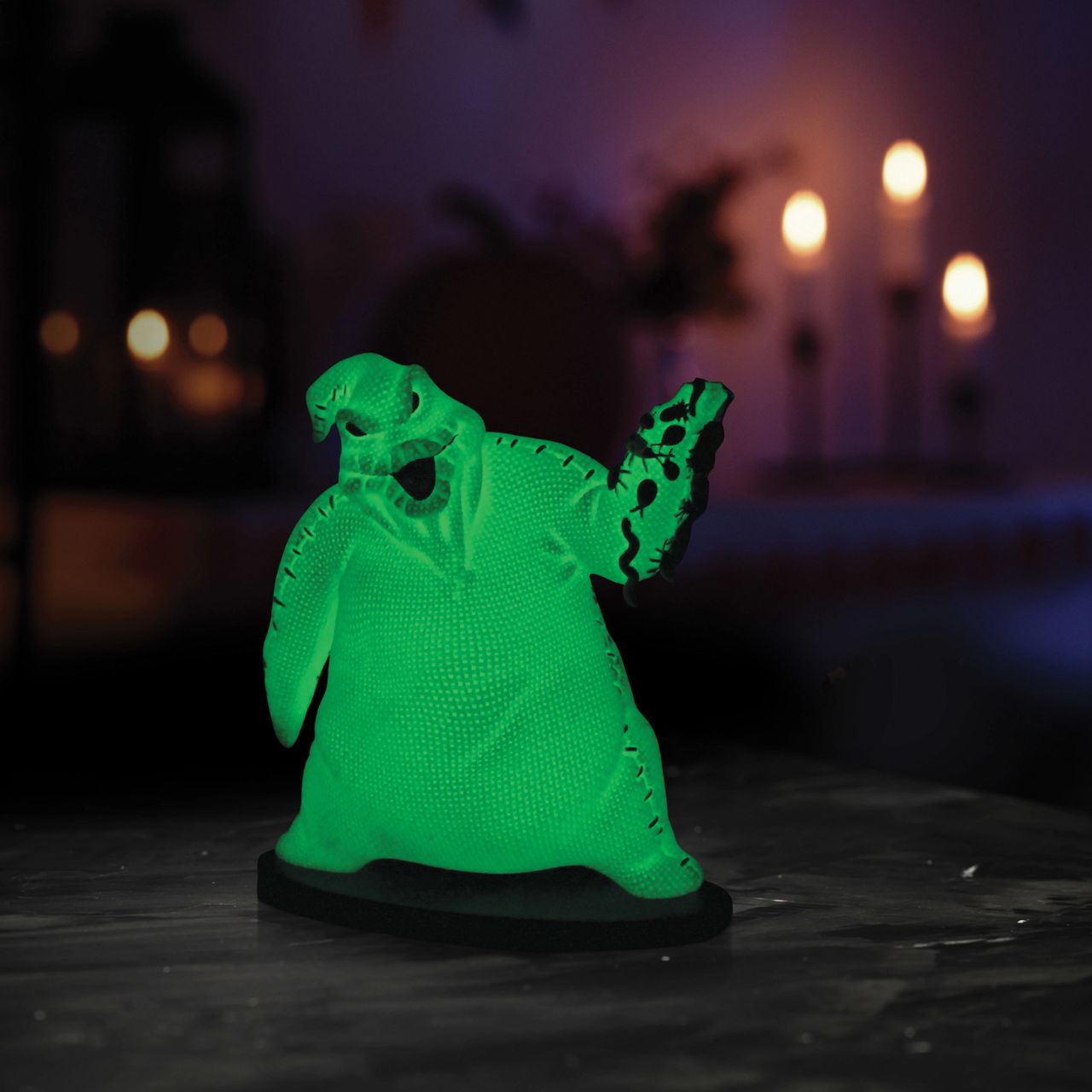 Imagine bringing home a piece of haunting magic with this Oogie Boogie glow-in-the-dark figurine. Every night will be full of delightful frights as Oogie Boogie, will let his ghostly glow add a touch of Halloween magic to your everyday.