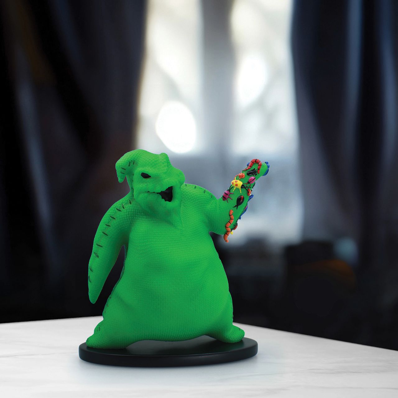 Imagine bringing home a piece of haunting magic with this Oogie Boogie glow-in-the-dark figurine. Every night will be full of delightful frights as Oogie Boogie, will let his ghostly glow add a touch of Halloween magic to your everyday.