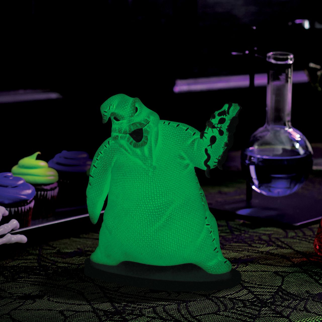 Imagine bringing home a piece of haunting magic with this Oogie Boogie glow-in-the-dark figurine. Every night will be full of delightful frights as Oogie Boogie, will let his ghostly glow add a touch of Halloween magic to your everyday.