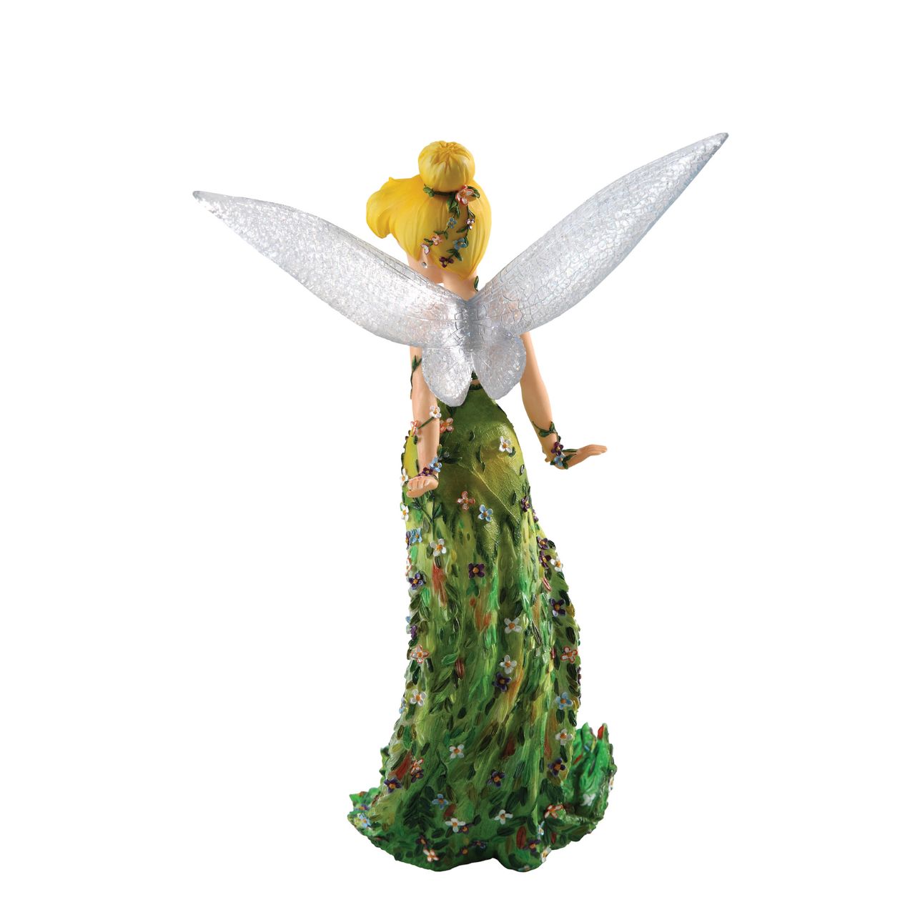 Tinker Bell pulls out all the stops in this high fashion figurine from our Haute Couture Collection. Delicate vines of flowers encircle her arms and dress and cover her dramatic, floor-sweeping train.