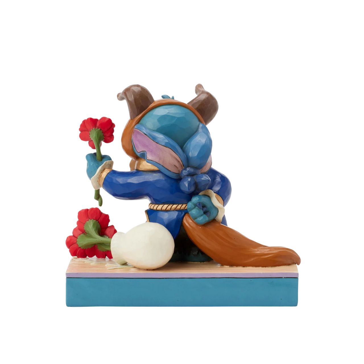 In this charming Jim Shore design, Stitch takes on the role of the Beast from Disney's beloved tale, dressed in the iconic blue suit. With an adorable smile, Stitch presents a flower, to you the collector.