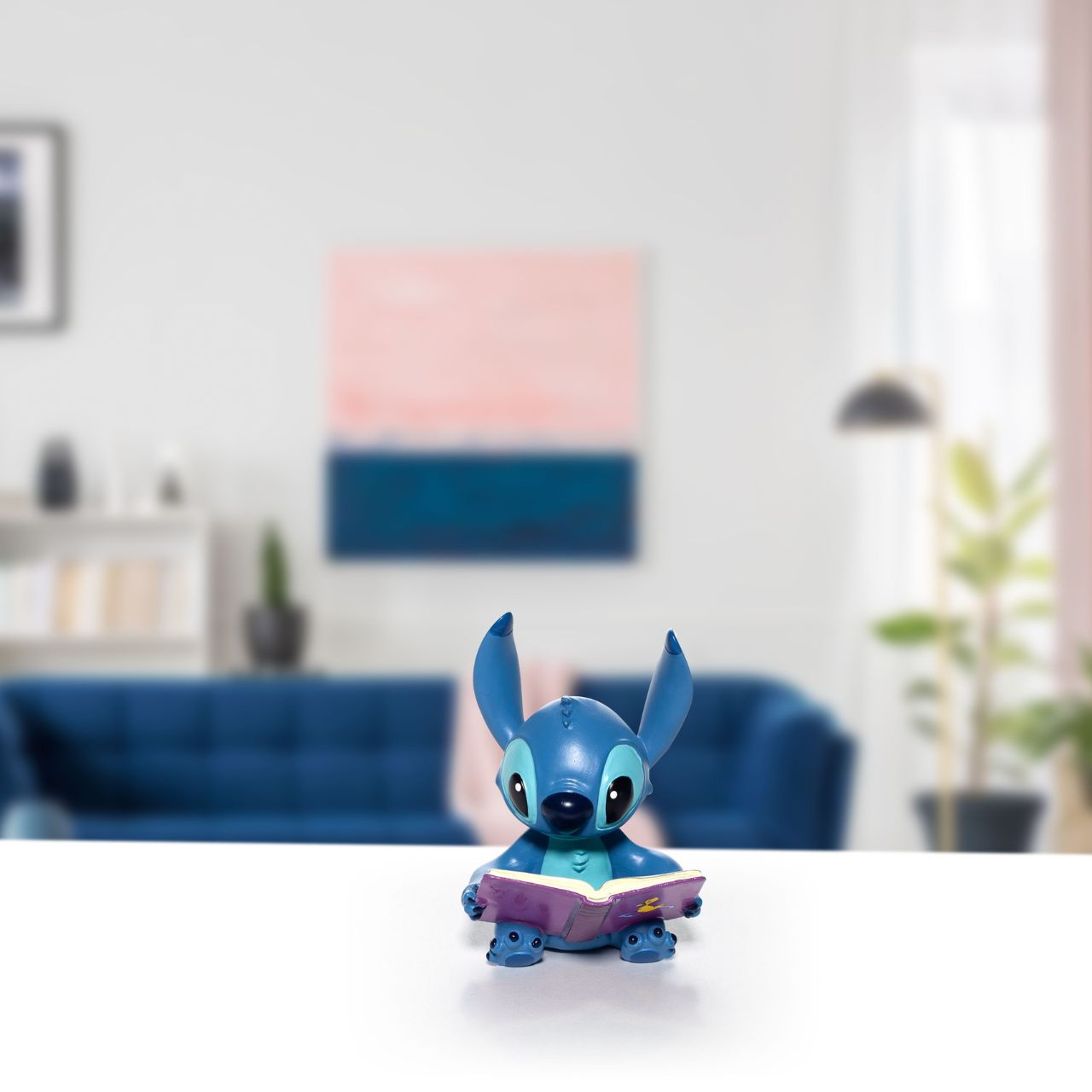 Disney Showcase Stitch Book Figurine Even adorable Stitch loves a good read. Yes he is cute, charismatic and clever. Ohana means family , making this delightful Stitch a much welcomes addition to the collection of six minis . Hand-painted and hand crafted, Stitch is supplied in a windowed branded gift box.