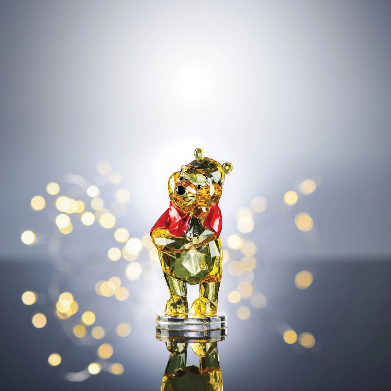 Disney Winnie The Pooh Facets Figurine This "gem cut" acrylic sculpture reflects Winnie the Pooh's honey-sweet charm and whimsical personality. Presented in a branded window gift box. Not a toy or childrens product. Intended for adults only.