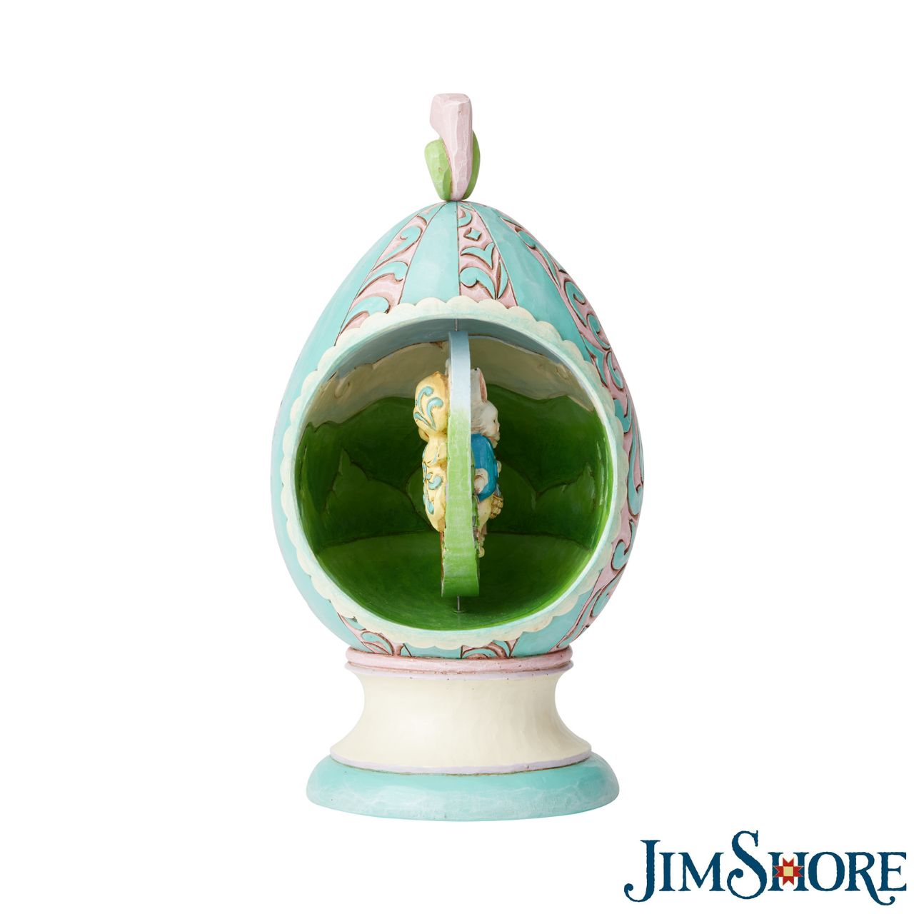 Revolving Egg with Bunnies and Chicks Scene Figurine by Jim Shore Stroll through Spring with this festive Jim Shore tabletop Easter egg. Simply turn the floral finial atop the egg to rotate the scene inside between two adorable Easter scenes. Chicks soak in the sun while a pair of bunnies jubilantly collect eggs.