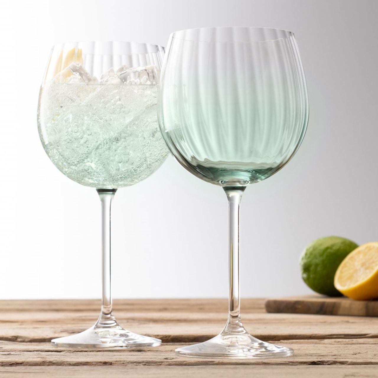 Galway Crystal Erne Gin & Tonic Pair Aqua  Aqua colour Gin and Tonic glasses in the Erne suite. Beautiful large balloon gin glasses with elegant lines design in an Aqua colour. The glass has been designed to add a splash of colour and light design to a stunning gin glass.