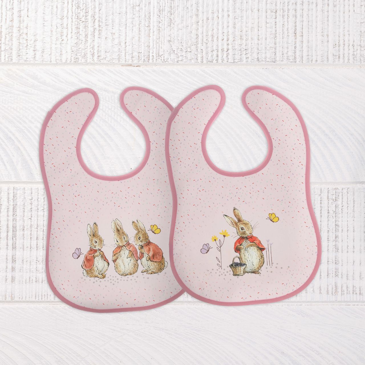 Introducing the delightful Flopsy Bunny Bib Set, inspired by the charming tales of Peter Rabbit and friends. This enchanting set of two bibs ensures mealtime is both stylish and mess-free. Crafted with super-soft, wipeable fabric, each bib features an easy hook & loop tape fastening for quick changes.