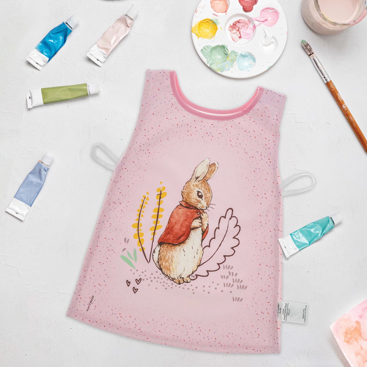 Introducing the charming Flopsy Bunny Tabard, designed with both style and practicality in mind. Featuring hook & loop tape fastening at the neck and elasticated sides, this bib is easy to put on and adjust, ensuring a snug fit for your little one.