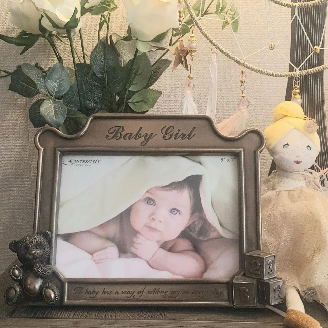 This beautiful photo frame comes with the message inscribed on the front ; "A baby has a way of adding joy to every day." The perfect gift for a new arrival or christening. It holds 5 x 7 photos, and is made of cold cast bronze, measuring, overall 7" x 9''.