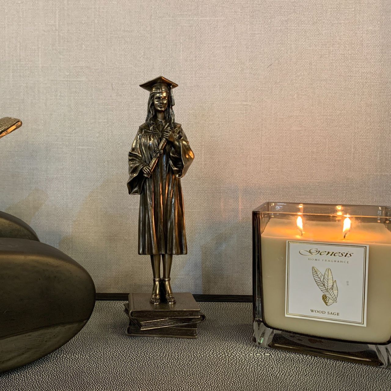 Genesis Female Graduate Figurine This stunning bronze figurine of a young woman on her graduation day would make the perfect graduation gift. Genesis Fine Arts has evolved into a much loved and world famous Irish brand to produce a striking range of handcrafted cold cast bronze sculptures.