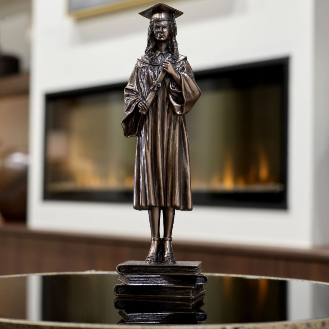 Genesis Female Graduate Figurine  This stunning bronze figurine of a young woman on her graduation day would make the perfect graduation gift.  Genesis Fine Arts has evolved into a much loved and world famous Irish brand to produce a striking range of handcrafted cold cast bronze sculptures.