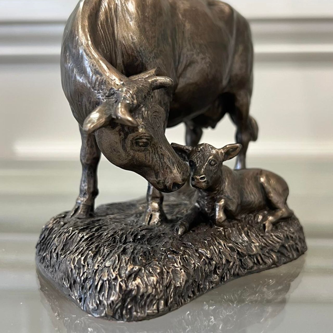 This Genesis Cow and Calf ornament is a rustic farmyard setting cast from bronze.