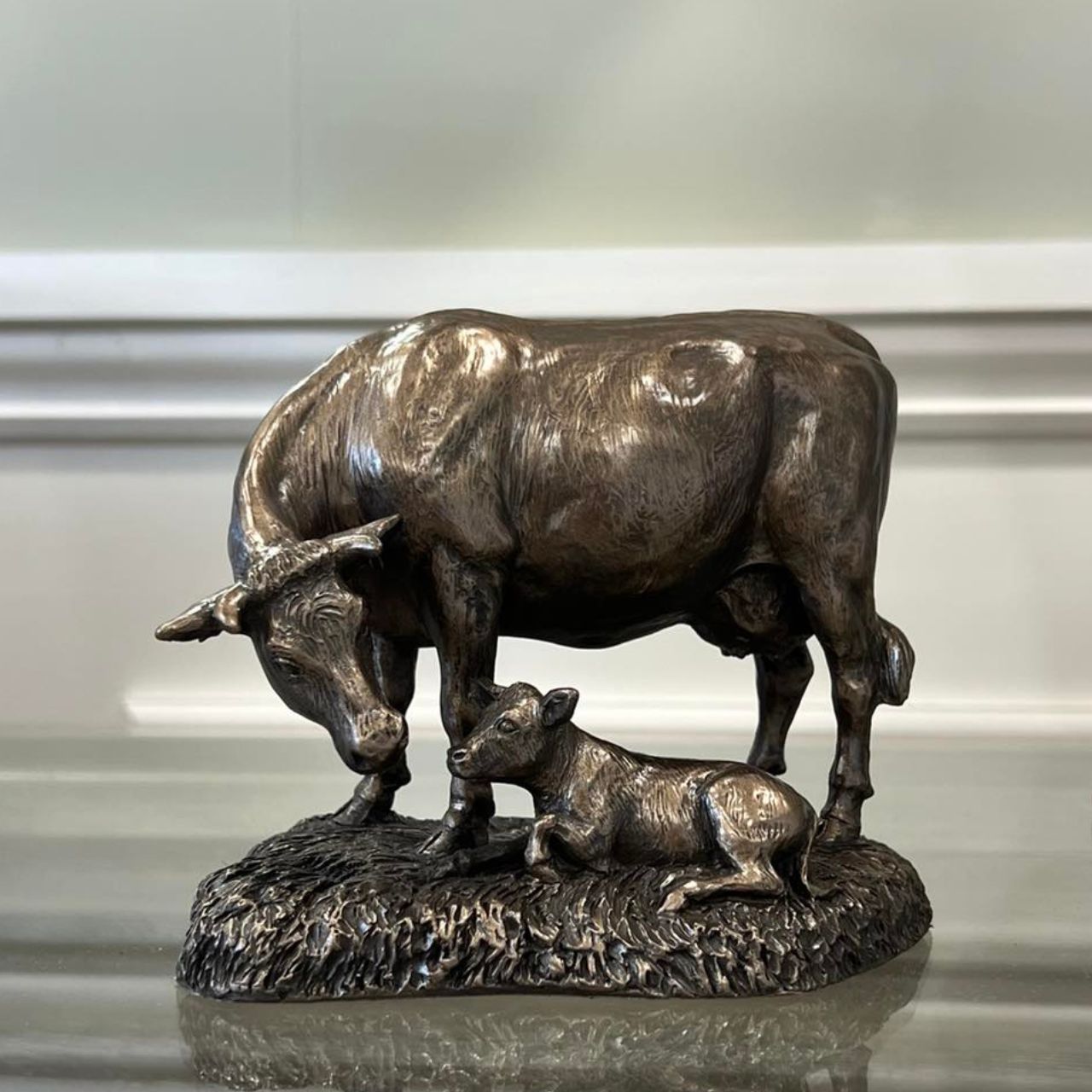 This Genesis Cow and Calf ornament is a rustic farmyard setting cast from bronze.