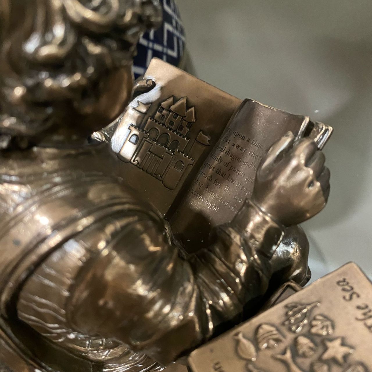 Discover a scene that resonates with the tranquillity of learning, a young boy engrossed in a world of imagination, sitting beside a stack of cherished books.