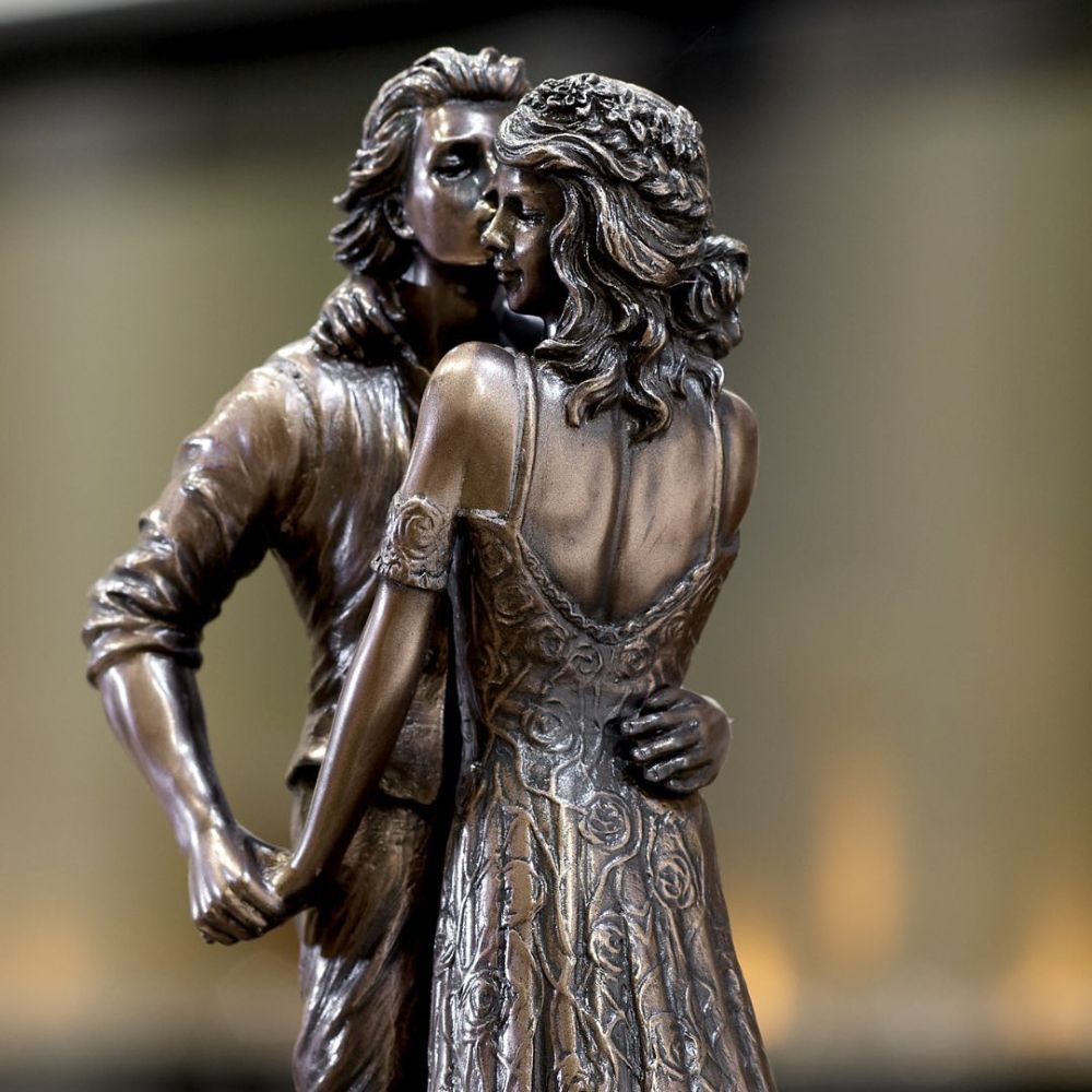 Love Boat by Genesis Ireland  A beautiful bronze coloured statue of a couple on their wedding day, sailing away in their love boat.