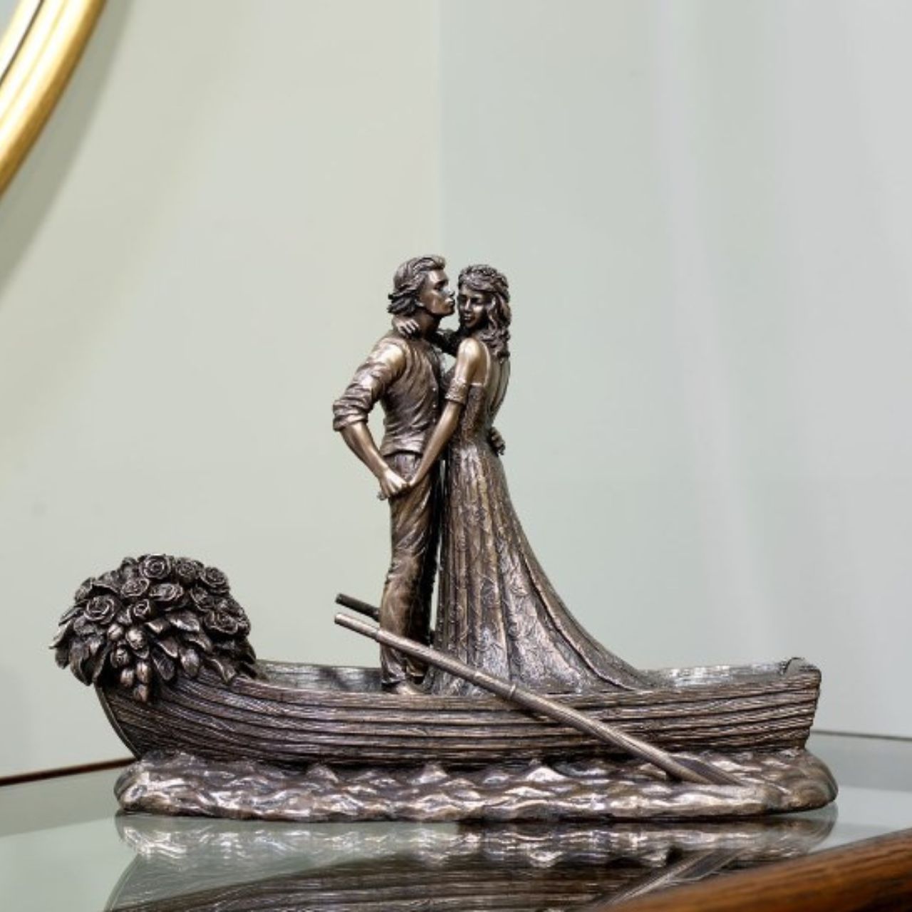 Love Boat by Genesis Ireland  A beautiful bronze coloured statue of a couple on their wedding day, sailing away in their love boat.