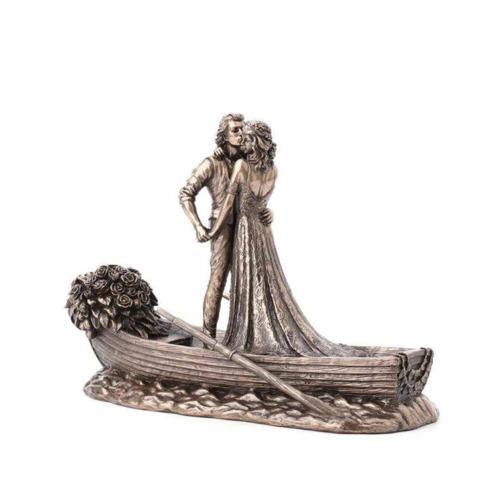 Love Boat by Genesis Ireland  A beautiful bronze coloured statue of a couple on their wedding day, sailing away in their love boat.  Perfect for art lovers or for an occasional gift such as a wedding or anniversary gift.