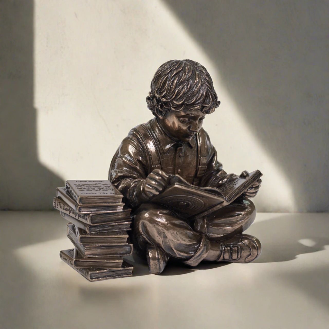 Discover a scene that resonates with the tranquillity of learning, a young boy engrossed in a world of imagination, sitting beside a stack of cherished books.