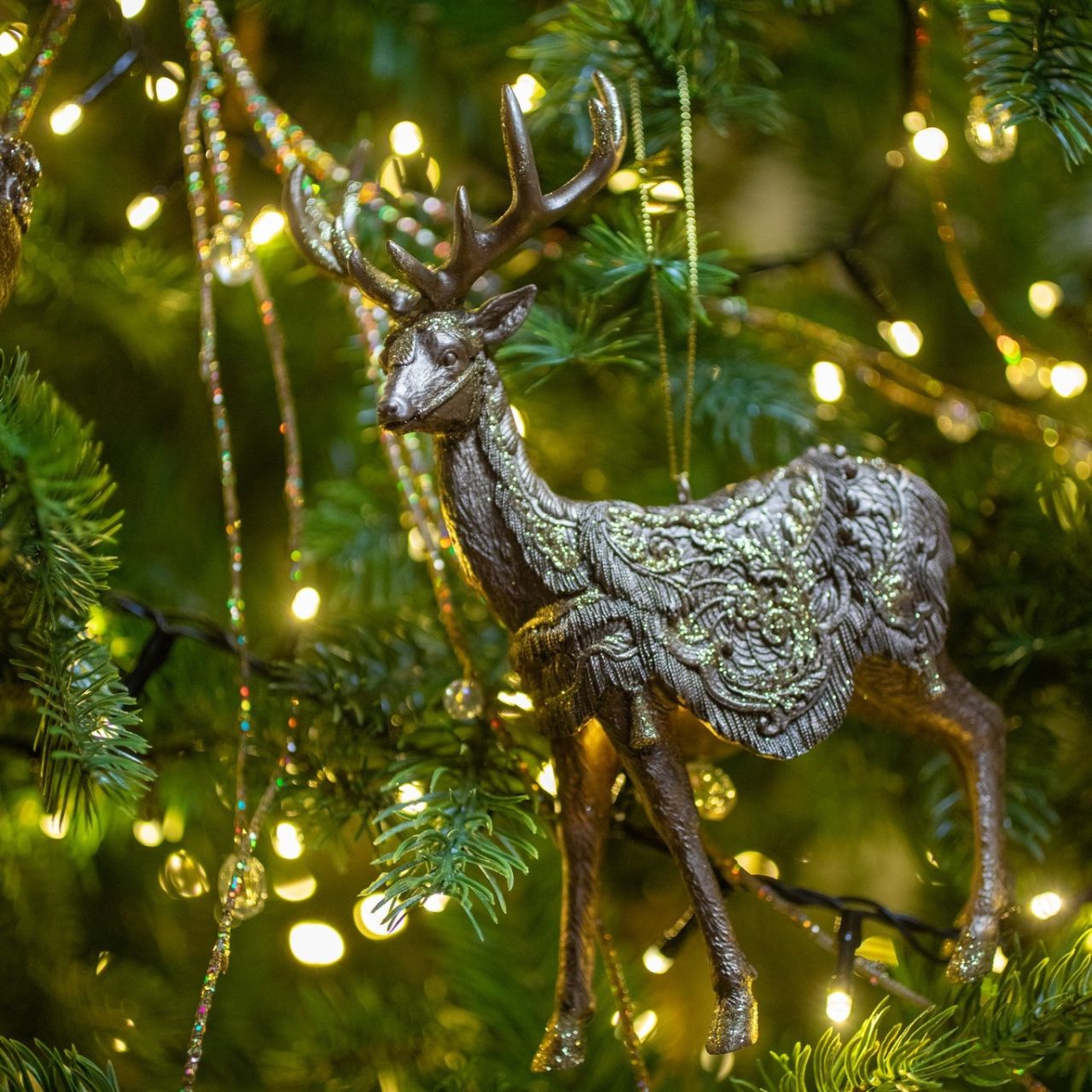 Reindeer Christmas Tree Ornament by Genesis  Gorgeous bronze coloured Christmas tree ornament by Genesis Ireland. With glittering gold accents, this ornament is sure to bring a sparkle to your Christmas décor.