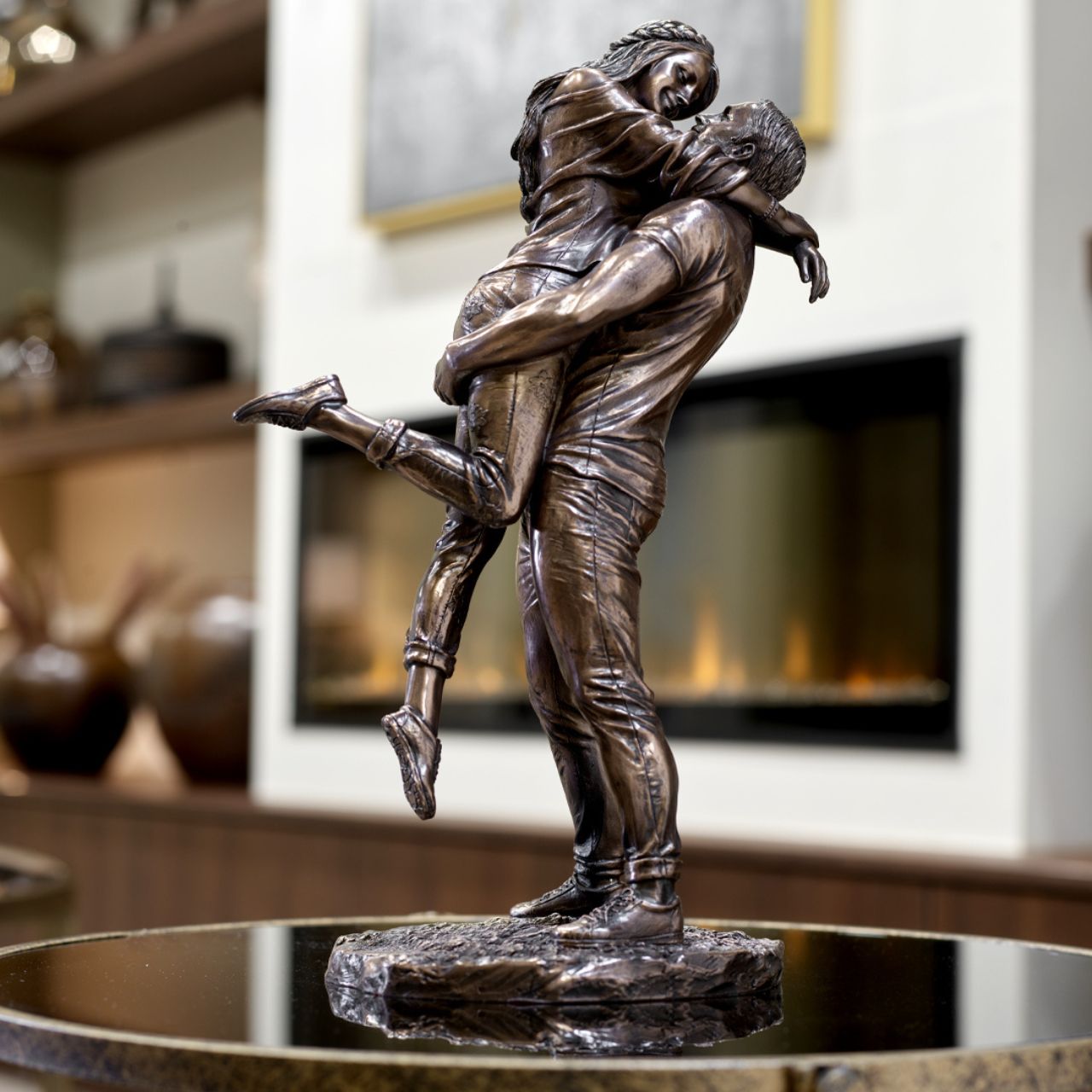The Promise by Genesis Ireland  A beautiful bronze coloured statue of a couple in a loving embrace.