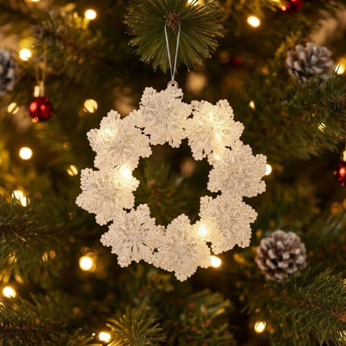 Bring festive elegance to your holiday décor with this stunning Gisela Graham Clear Snowflakes Wreath Hanging Ornament. Featuring delicate snowflake designs encased in clear acrylic, this ornament captures the magic of winter with sparkling glitter accents and fine painted details.