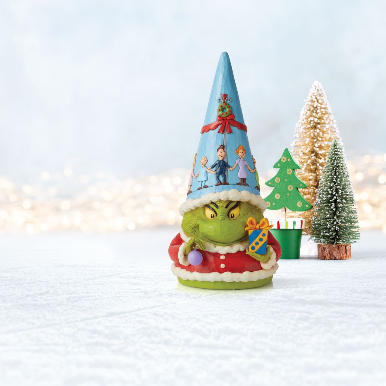 Wearing his infamous grin, The Grinch shrinks several sizes for this lovable gnome statute by Jim Shore. Disguised in Santa's coat, he's eager to sneak your Christmas tree this season. Perhaps you'll sway his heart before he steals your presents.