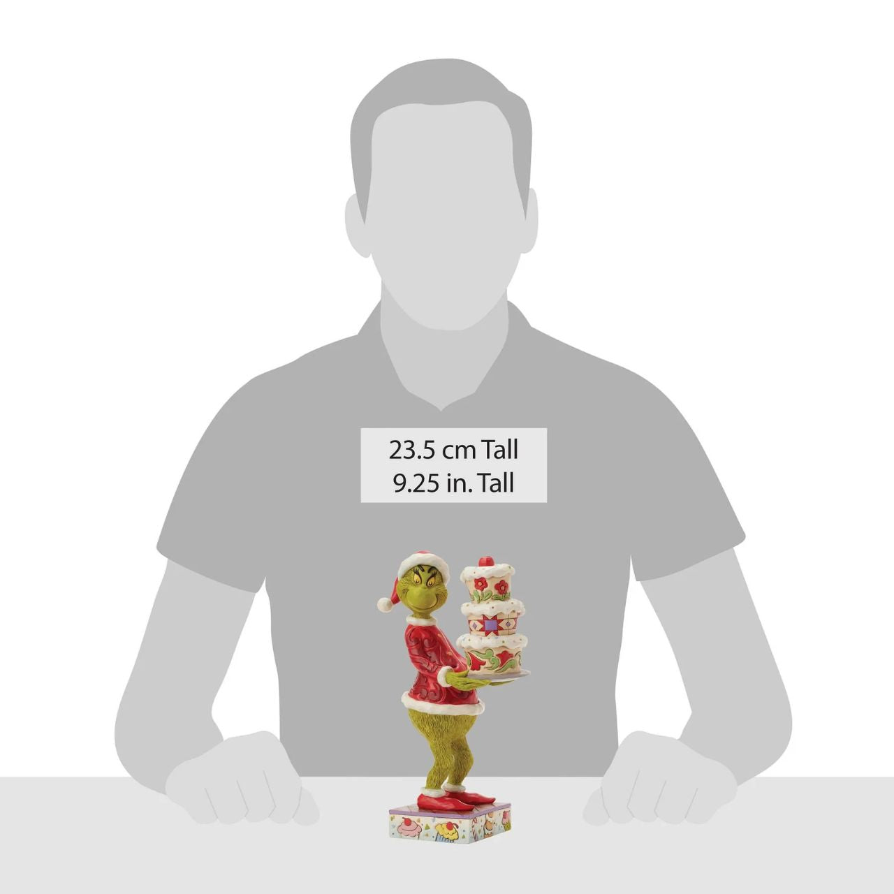 Disguised as Santa, The Grinch beams with trickery as he steals a towering cake. Adorned with Jim Shore's iconic rosemaling, patchwork patterns, and charming floral details, this piece captures the mischief of Christmas in true Grinch fashion.