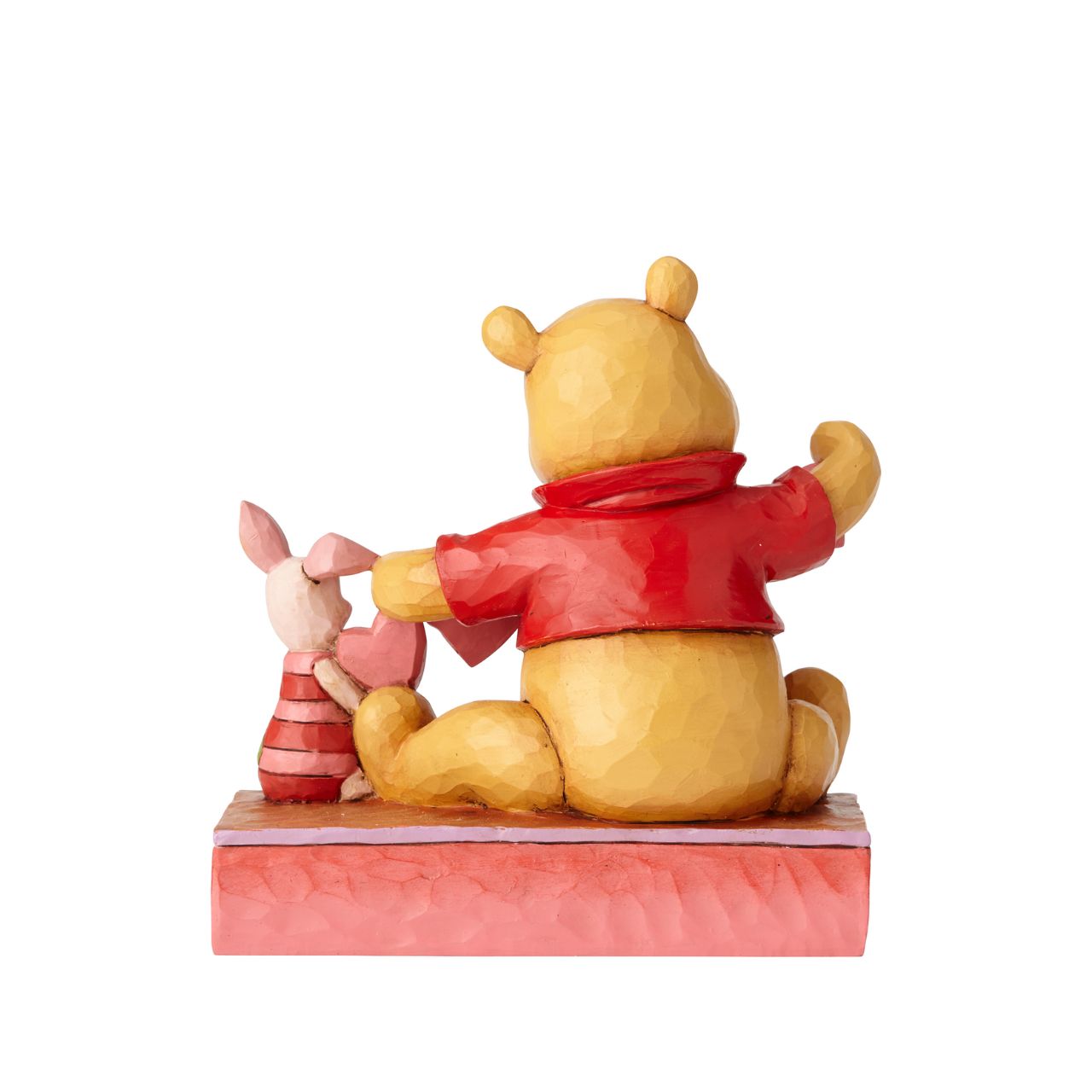 Disney Traditions Handmade Valentines Pooh and Piglet Figurine Will you be Pooh's Valentine? Piglet and Winnie the Pooh sit close beside each other as they trace and snip a handmade garland of hearts. Folk art-inspired details add to the artisanal charm of this hand-painted figurine, sculpted from high-quality cast stone.