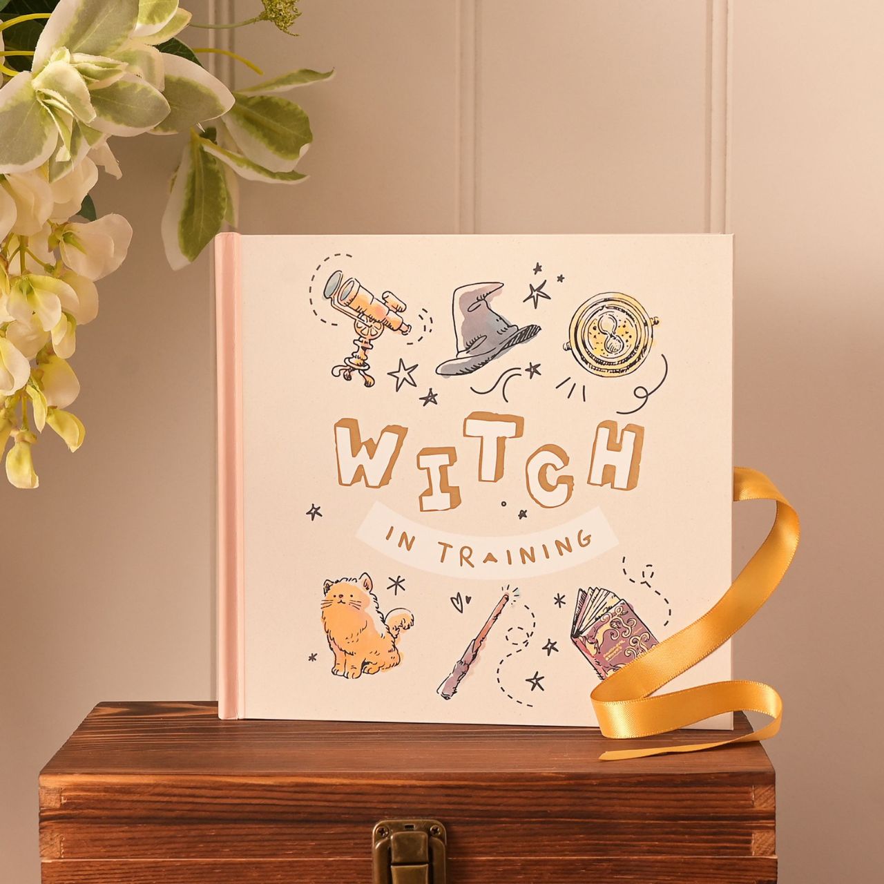 This mystical photo album is perfect for presenting photographs of young witches.