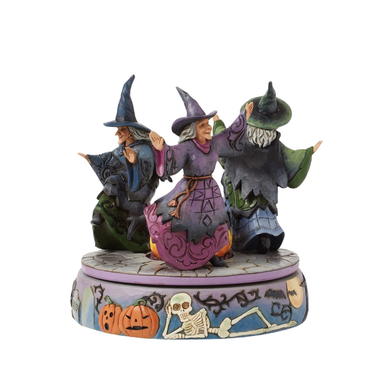 Enter the world of Halloween with this hand-touch rotation Jim Shore movement figurine featuring two witches dancing around a bubbling cauldron. Adorned with jack-o-lanterns, skeletons, tombstones, spiders, snakes, black cats, and bats, it's a bewitching scene.