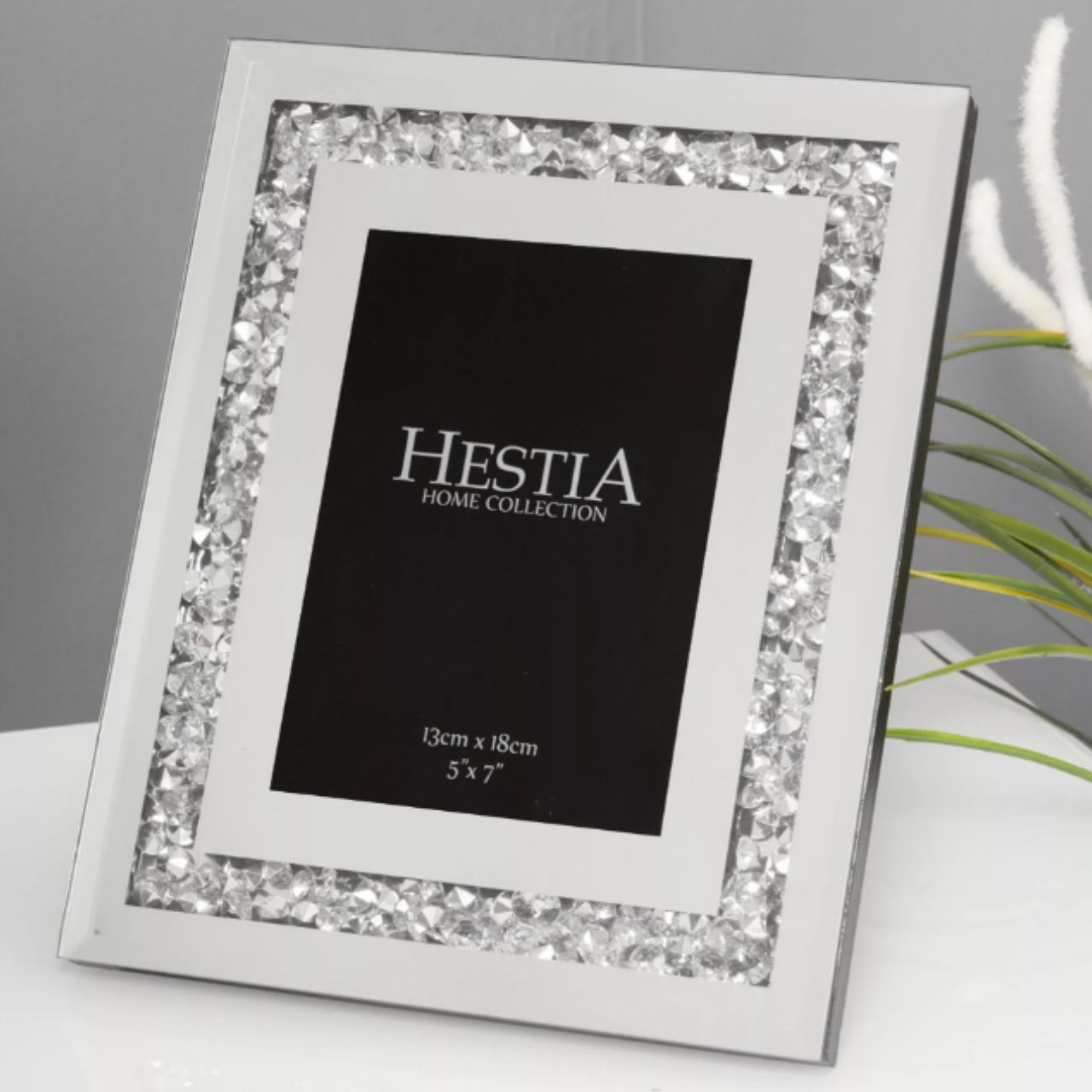 An elegant 5" x 7" aperture photo frame with mirrored glass and crystal edge detail. This beautiful frame is the perfect way to compliment a treasured photograph with glamorous and eye-catching style.